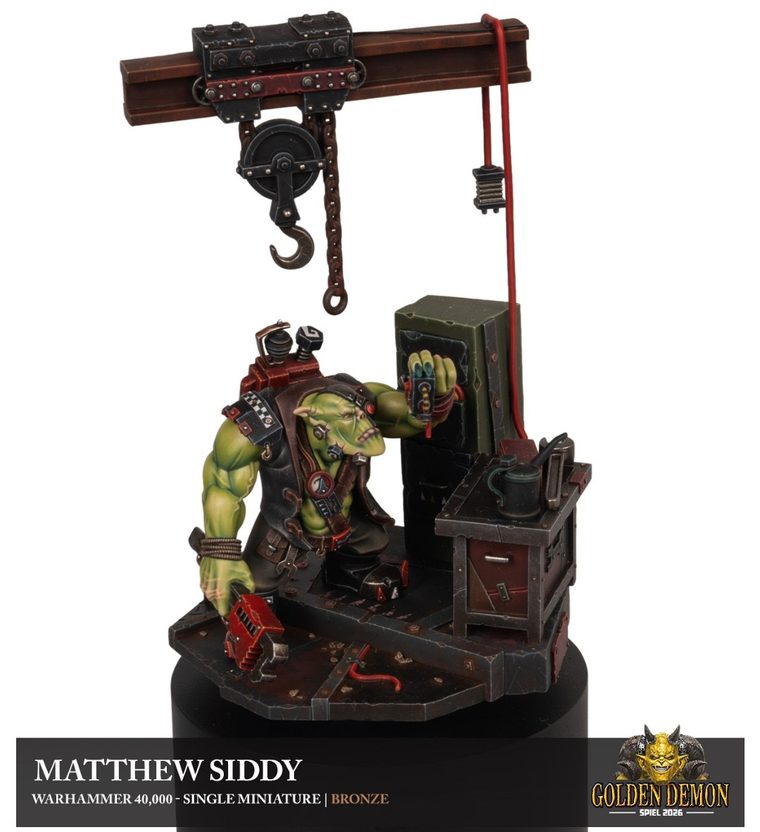 Ork mechanic in a workshop with a chain hoist, painted by Matthew Siddy
