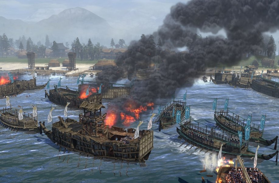 Burning Japanese warships in a naval battle near a coastal town