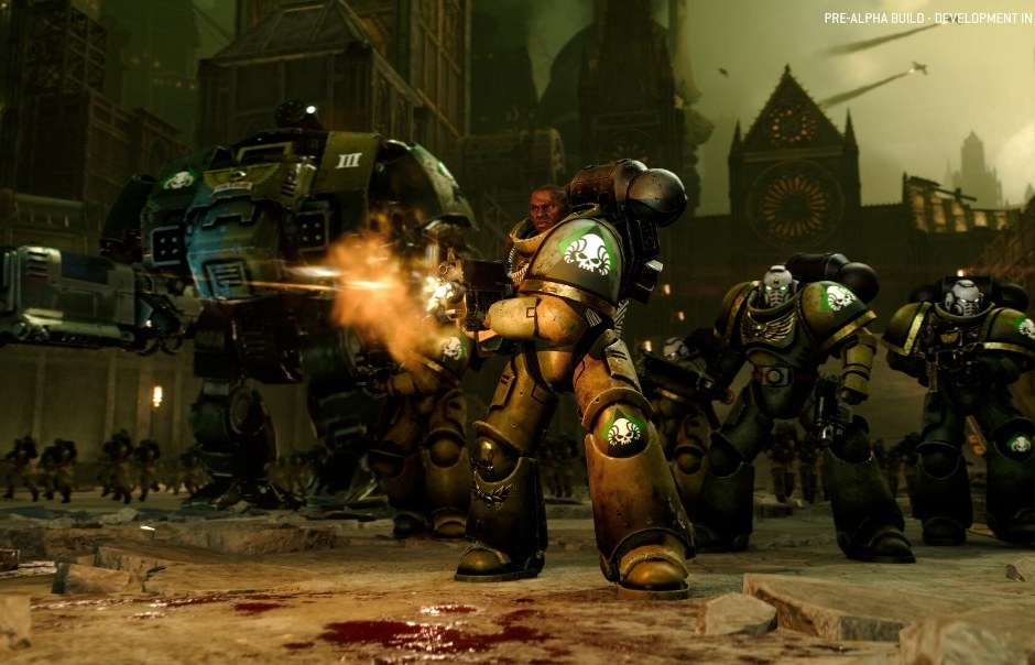 A squad of green-armoured Space Marines firing beside a Dreadnought in a ruined city