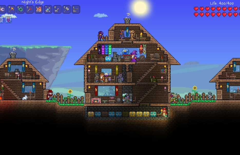 A large Terraria base with wooden houses and many NPCs living in separate rooms