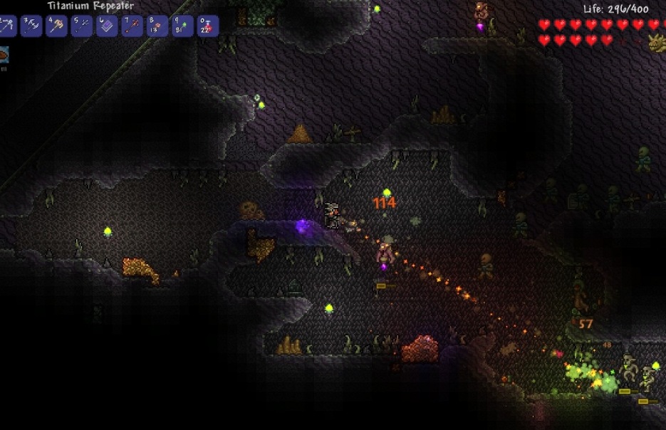 A Terraria player fighting enemies in a dark underground cave